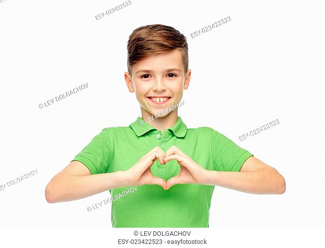 childhood, love, charity, health care and people concept - happy smiling boy in green polo t-shirt showing heart hand sign