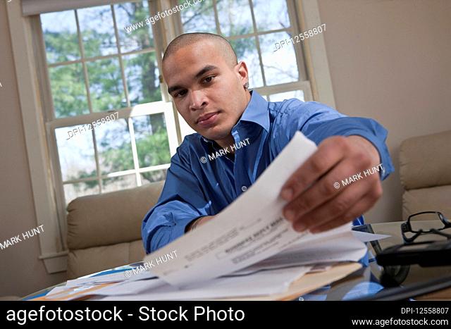 Young male professional working at a table from home
