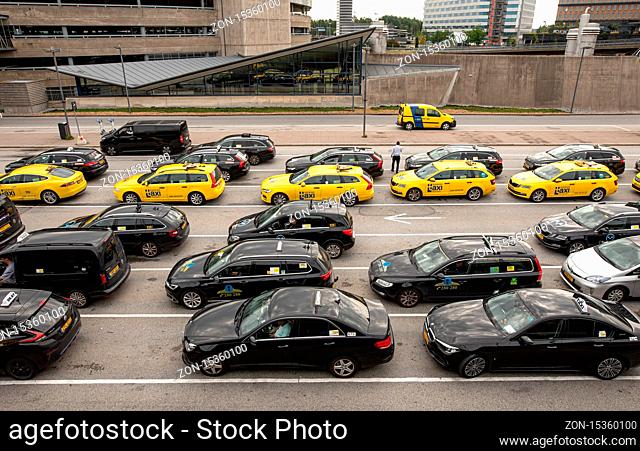 Stockholm/Sweden - August 8, 2019: Wiev on a lot of black and yellow taxi cars on a parking in Arlanda airport