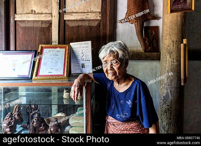 Cambodia, Battambang, Wat Kor Village, Khor Sang House, older Cambodian woman, owner of traditional Khmer wood house built by her grandfather, no releases