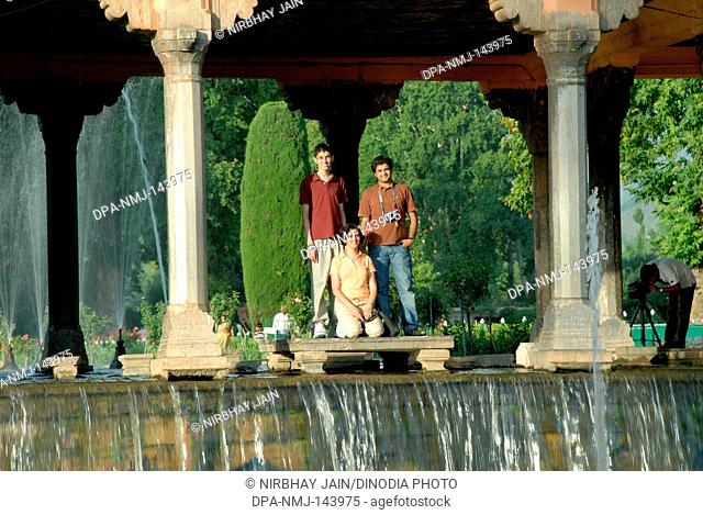 Family enjoying Shalimar gardens at Srinagar ; Jammu & Kashmir ; India