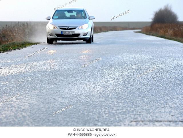 After a hailstorm a car drives carefully over a glassy street in Pilsum, Germany, 06 December 2013. Storm front Xaver has reached the North Sea in Germany full...