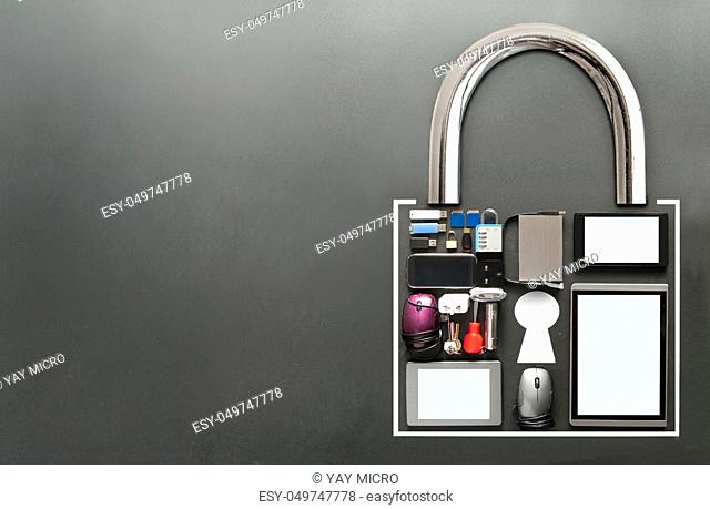 Various devices including tablets, computer mouse, usb cards in the shape of a padlock on a chalkboard background