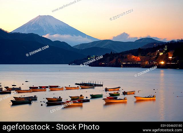 The view of boats in the harbor of Lake Ashinoko with Mount Fuji on the background at the sunset. Kanagawa. Honshu. Japan