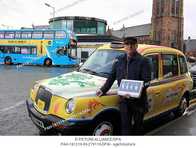 30 November 2018, Great Britain, Liverpool: Ian Doyle takes his ""psychedelic taxi in John Lennon colors"" to tourists to the Beatles attractions in Liverpool