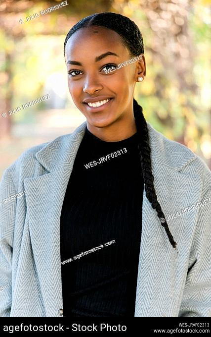 Beautiful teenage girl smiling wearing trench coat