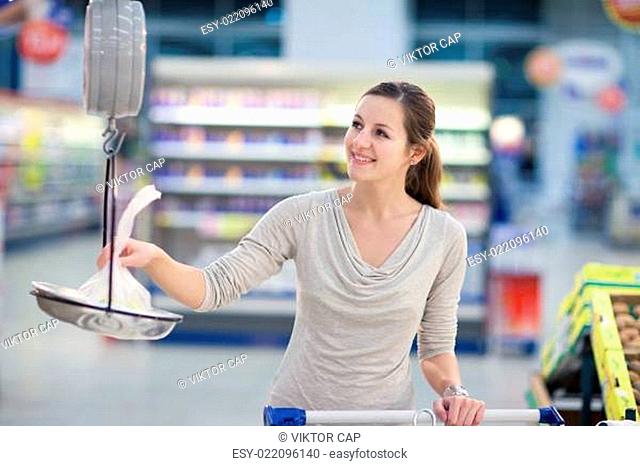 Pretty young woman shopping in a supermarket