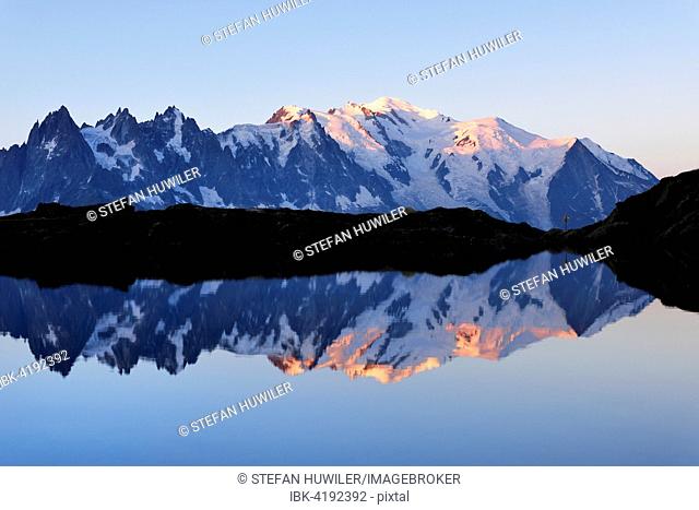 Mont Blanc massif at sunrise reflected in Lac de Chésserys, Montblanc on the right, Chamonix, France