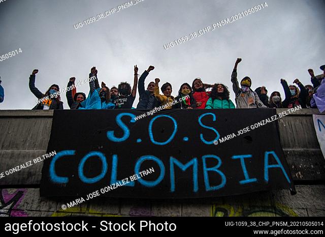 A group of demonstratos hang a sign on a bridge that reads ""S.O.S Colombia"" after police and military started killing demonstrators in Colombian cities on may...