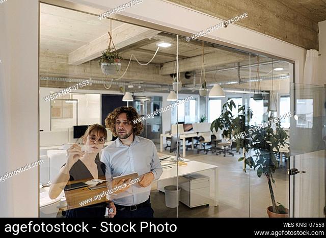 Businessman and businesswoman working on a project in office