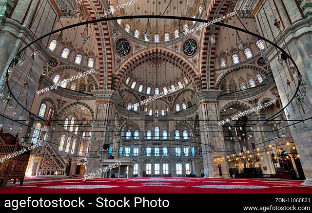 Fatih Mosque, a public Ottoman mosque in the Fatih district of Istanbul, Turkey, with a huge decorated domes many colored stained glass windows
