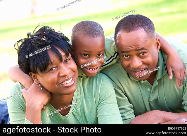 Man, woman and child having fun in the park
