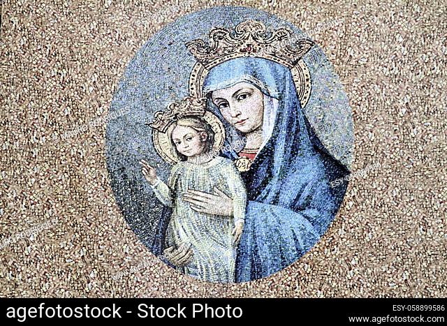 View of an artistic painting of Virgin Mary with child on the corner of a street in Rome, Italy