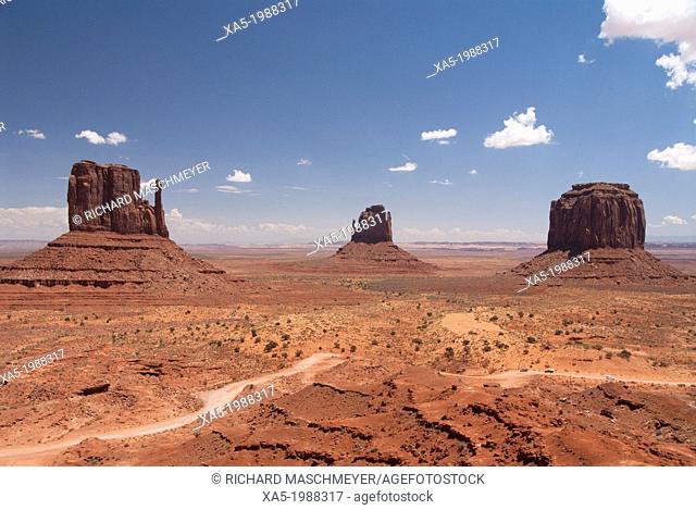 USA, Utah, Monument Valley Navajo Tribal Park, Park Road (foreground), West and East Mittens Left, Merrick Butte (right)