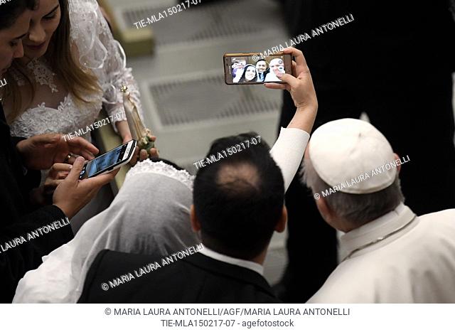 A young couple taking a selfie with Pope Francis during the General Audience. Vatican City. Vatican 15/02/2017
