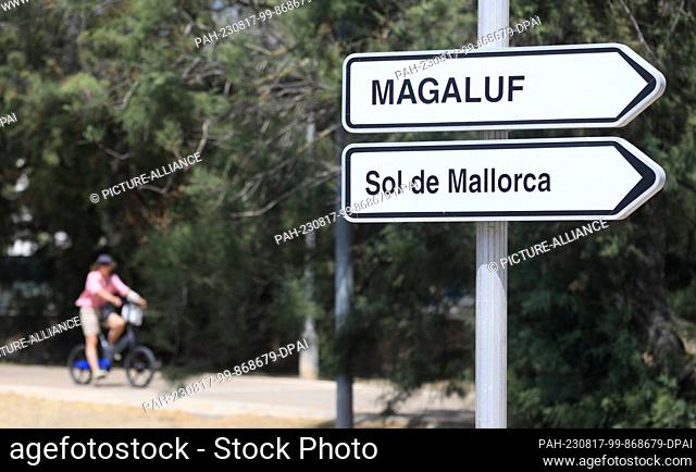 17 August 2023, Spain, Mallorca: Signposts show the direction to Magaluf and Sol de Mallorca on the roadside. Police and the judiciary have to deal with an...