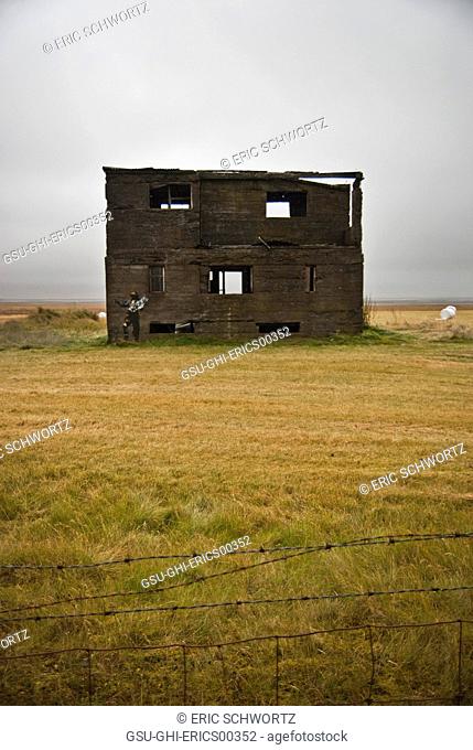 Abandoned Building in Field Behind Barbed Wire Fence, Iceland