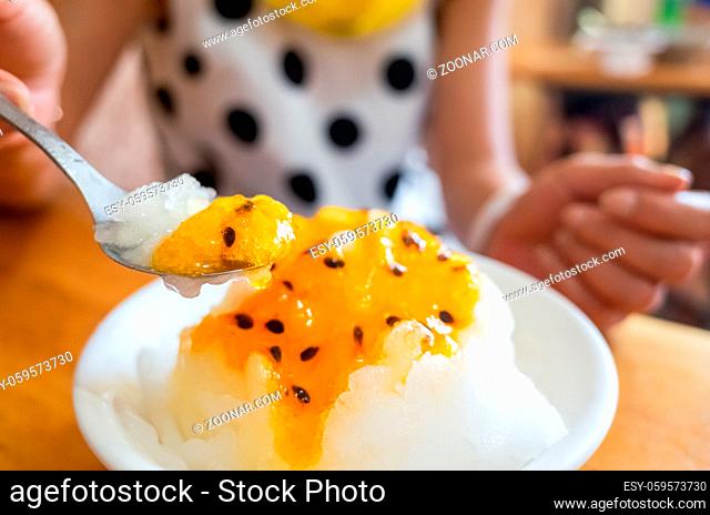 eating passion fruit shaved ice in the restaurant