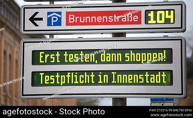 16 March 2021, Baden-Wuerttemberg, Tübingen: A billboard on a street near downtown reads ""Test first, shop later! Compulsory testing in the city centre""