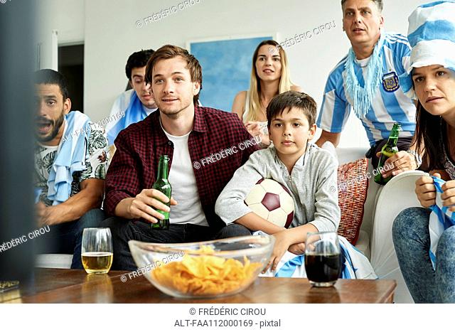 Argentinian football fans watching football match at home