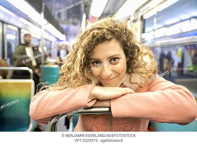 woman in public transport metro train, in Paris, France