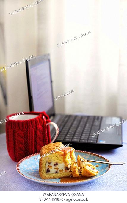 A slice of Cassata Siciliana next to a laptop