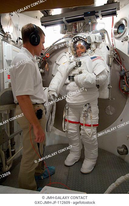 Astronaut Heidemarie M. Stefanyshyn-Piper, STS-126 mission specialist, participates in an Extravehicular Mobility Unit (EMU) spacesuit fit check in the Space...