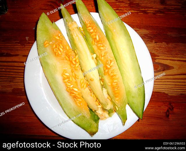 Varietal cut melon lies on a the plate
