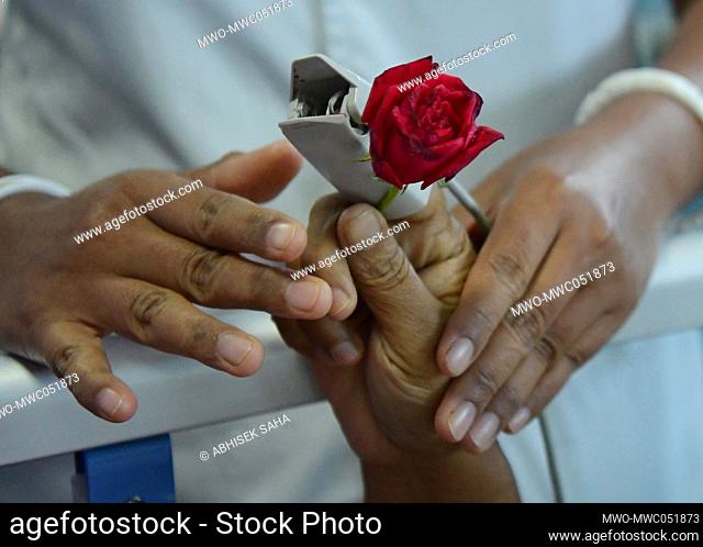 A nurse distributes a rose to a cancer patient on World Rose Day for the welfare of cancer patients which is observed every year on September 22nd to create...