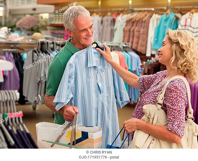 Couple shopping for clothing in store