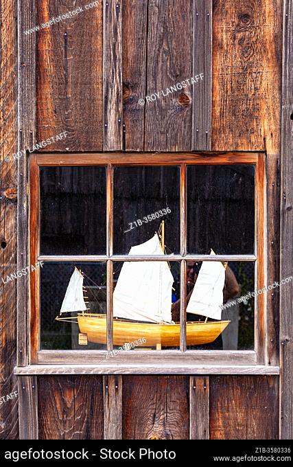 Model boat on display in the window of a workshop at the Britannia Ship Yard site in Steveston British Columbia Canada