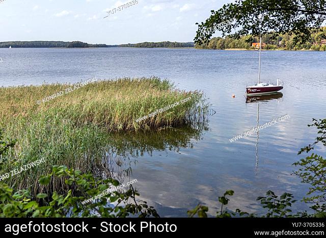 Sail boat on Narie Lake located in Ilawa Lakeland region, view from Kretowiny village, Ostroda County, Warmia and Mazury province of Poland