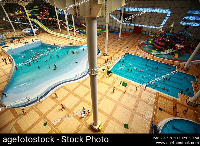19 July 2022, Iraq, Baghdad: People swim at an Aqua Park amid an ongoing heatwave in Iraq. Iraq experiences a heatwave with temperatures soaring to over 45...