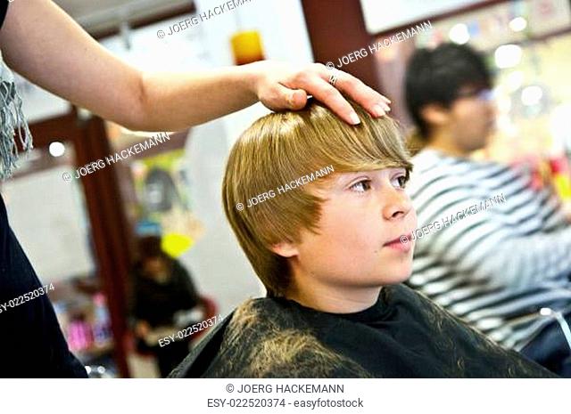young boy at the hairdresser