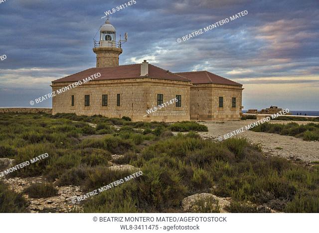 Sunset at the lighthouse of Punta Nati (Menorca, Baleares - Spain). Cloudy day in the lighthouse (one of the most famous lighthouse in Menorca)