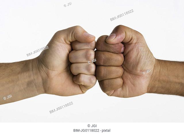 Close up of two hands touching knuckles together
