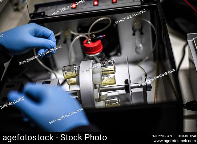 04 August 2022, Israel, Rehovot: Jacob (Yaqub) Hanna, Professor of Molecular Genetics, operates a bioreactor in his laboratory at Weizmann Institute of Science...