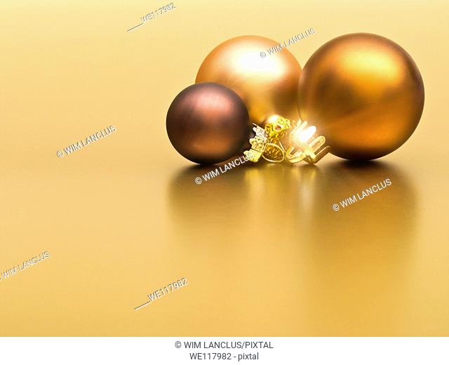 Christmas baubles on golden background