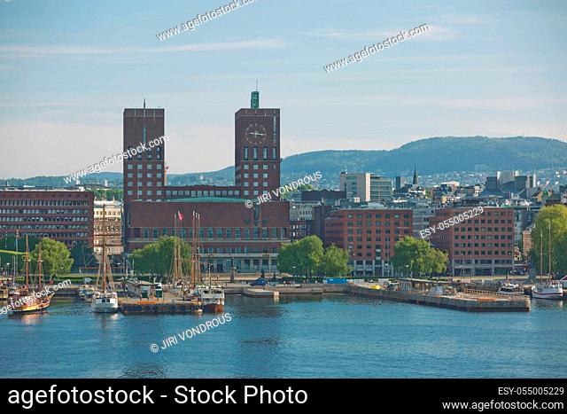 OSLO, NORWAY - MAY 27, 2017: Harbor and red brick City Hall (Radhuset) of Oslo, Norway. City Hall designed by Arnstein Arneberg and Magnus Poulsson