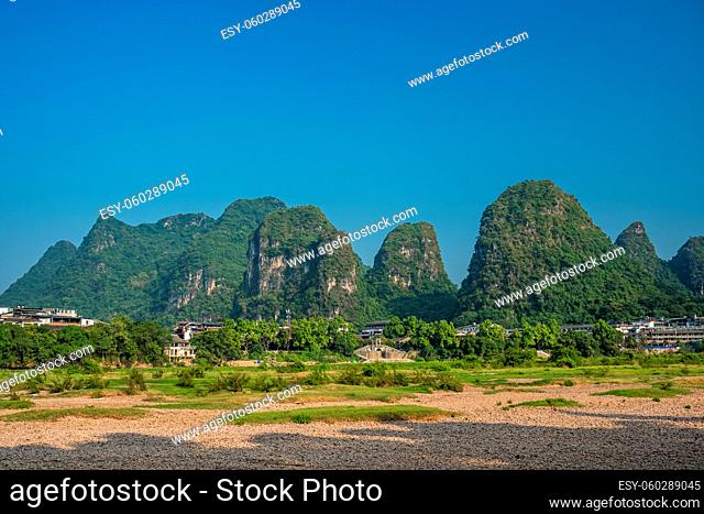 Yangshuo, China - August 2019 : Riverbank scenery of the Li river shore, the ferry crossing point, Guangxi Province