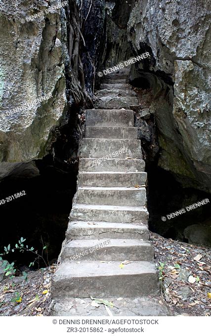 Stairway into a network of caves with buddhist statues outside the resort town of Kep, Cambodia