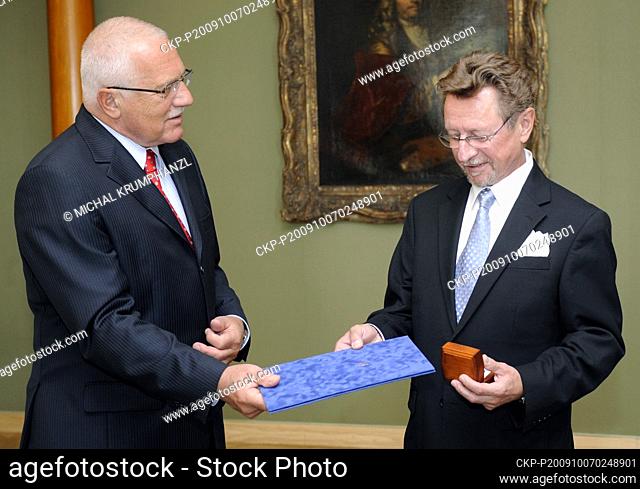 Czech President Vaclav Klaus, left, awards Czech musician George Mraz with the President's Golden Plaque on his 65th birthday in Prague, Czech Republic