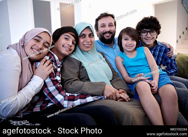 muslim family portrait with arab teenage kids at modern home interior