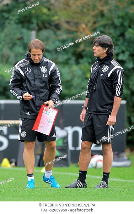 National soccer team coach Joachim Loew (R) and his assistant coach Thomas Schneider at practice for the German national soccer team at the training grounds...