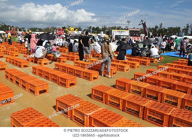 Uruma City, Okinawa, Japan, Orion beer boxes used as chairs at Eisa Festival
