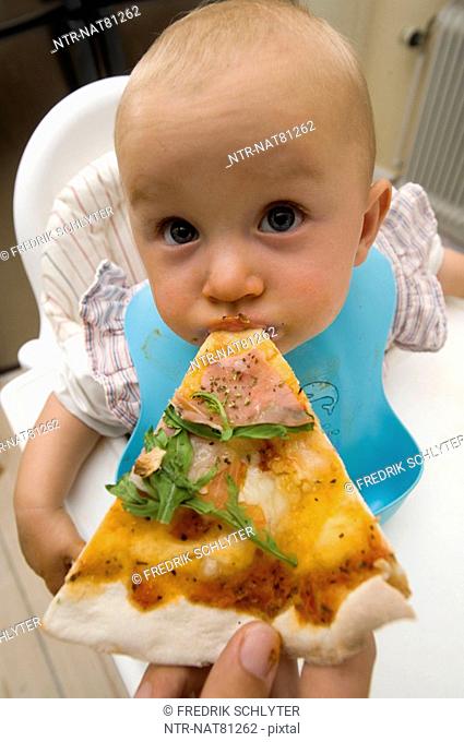 A baby eating pizza, Sweden