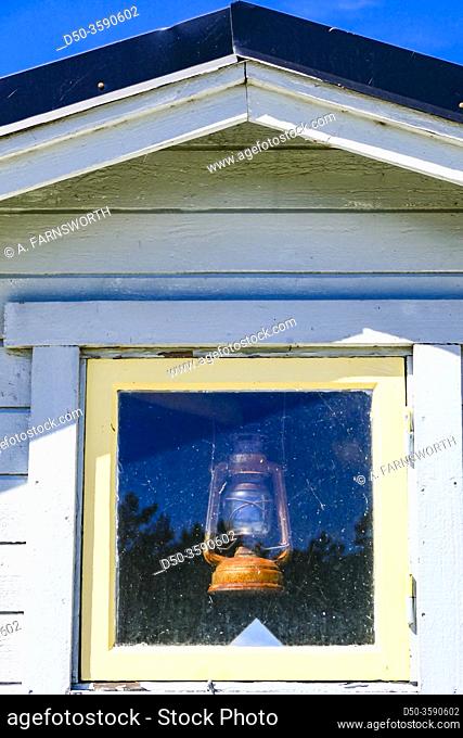 Falsterbo, Sweden Small seaside cottages by the seashore in the Flommen nature reserve and an oil lamp in window