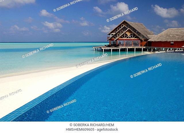 Maldives, South Male Atoll, Dhigu Island, Anantara Resort and Spa Hotel, swimming pool and white sand beach overlooked by a restaurant on stilts in the lagoon