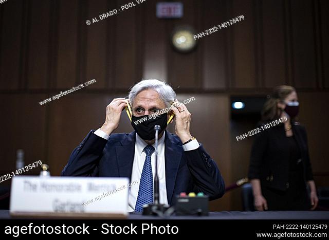 Attorney General nominee Merrick Garland puts on a protective mask during a break during his confirmation hearing before the Senate Judiciary Committee in the...