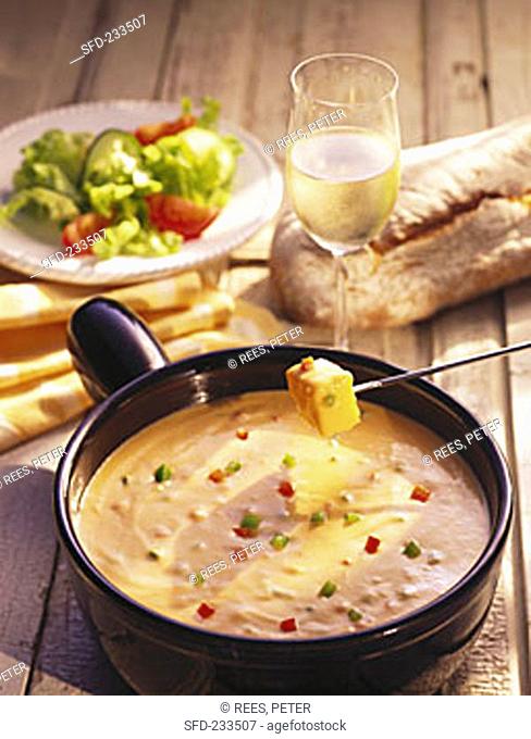 French cheese fondue with peppers, white wine, bread, salad